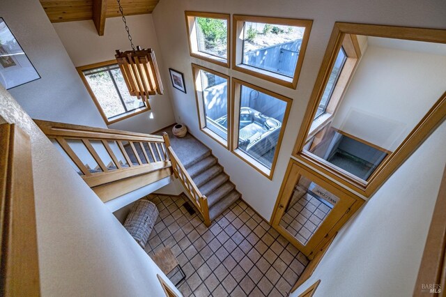 home office featuring wooden ceiling, built in desk, lofted ceiling with beams, and light hardwood / wood-style floors