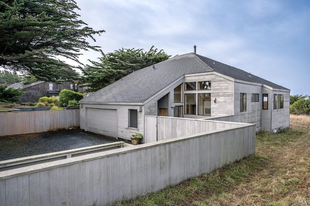 back of property featuring a garage