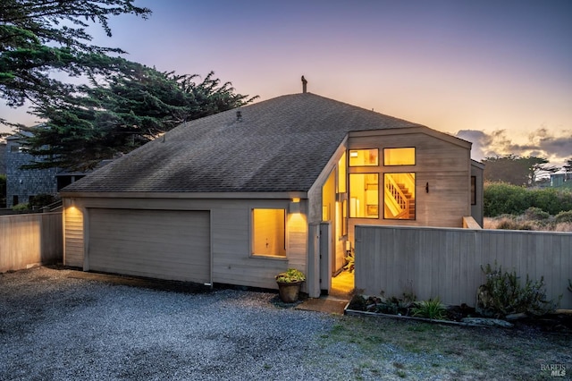 view of back house at dusk