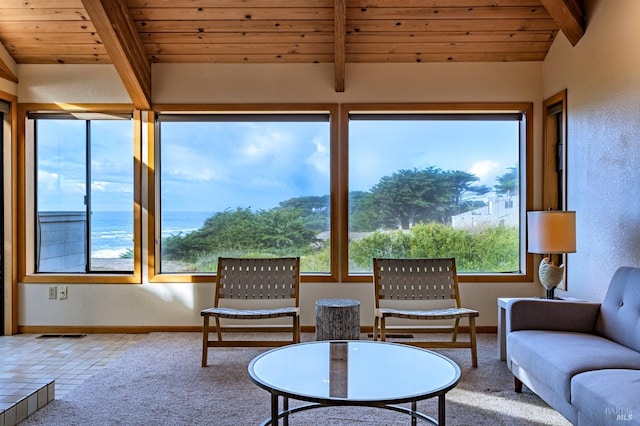 unfurnished sunroom with lofted ceiling with beams, wooden ceiling, and a tile fireplace