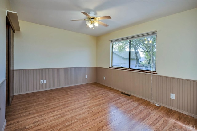 spare room featuring ceiling fan and light hardwood / wood-style flooring