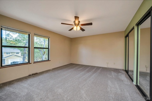 unfurnished bedroom featuring carpet floors and ceiling fan