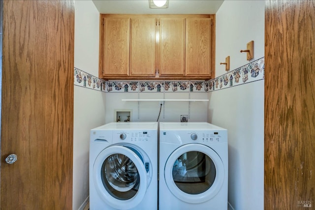 laundry room featuring cabinets and independent washer and dryer