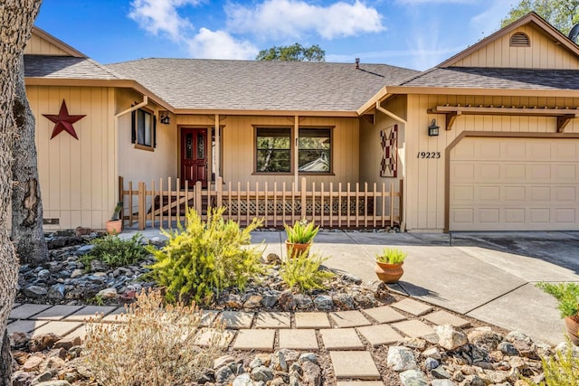 single story home featuring a garage and covered porch