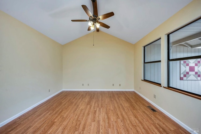 empty room featuring ceiling fan, light wood-type flooring, and vaulted ceiling