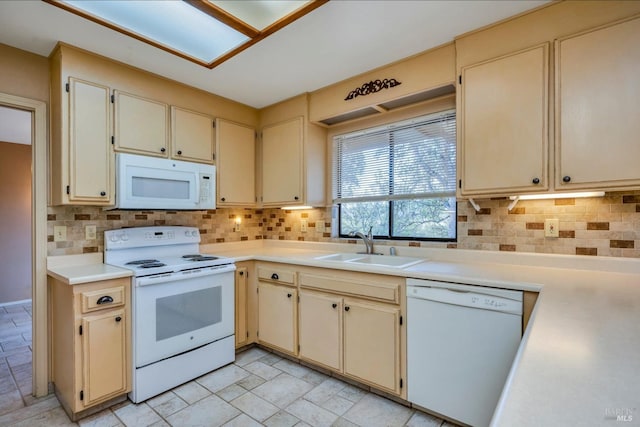 kitchen with decorative backsplash, sink, white appliances, and cream cabinets