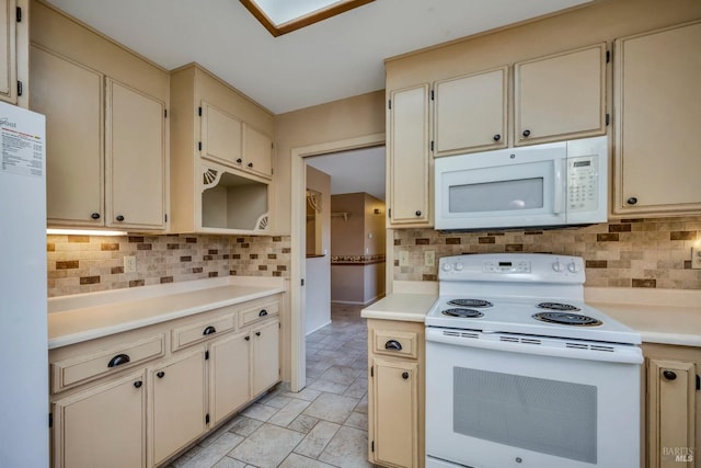 kitchen with decorative backsplash, white appliances, and cream cabinets