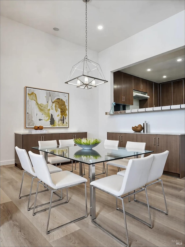 dining area featuring a notable chandelier and light hardwood / wood-style floors