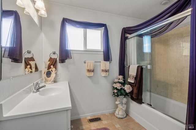 bathroom featuring bath / shower combo with glass door and vanity