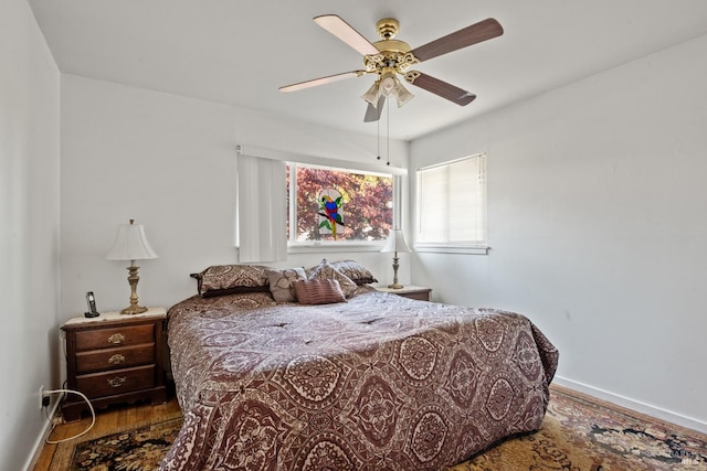 bedroom with wood-type flooring and ceiling fan