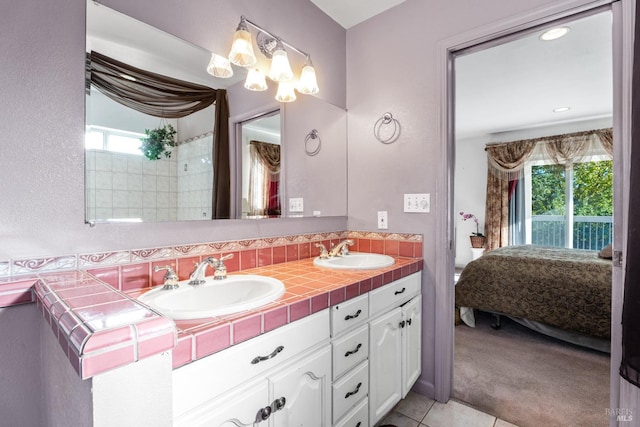 bathroom with vanity, tile patterned flooring, and a healthy amount of sunlight