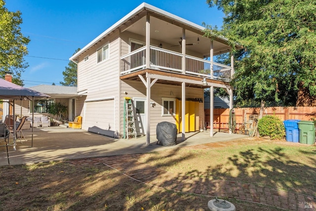 rear view of house with a balcony and a patio