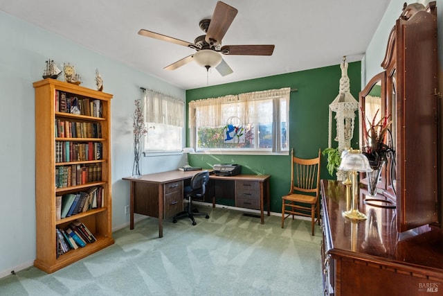 home office featuring ceiling fan and light carpet