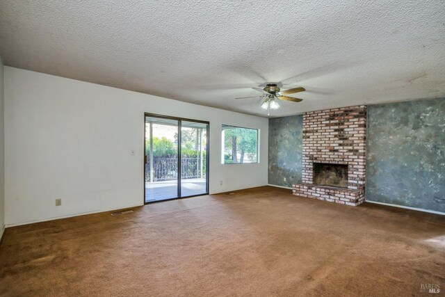 carpeted empty room with ceiling fan and a textured ceiling