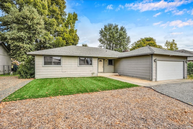 single story home featuring a garage and a front lawn