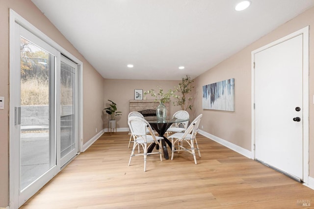dining area with light wood-style flooring, baseboards, and recessed lighting