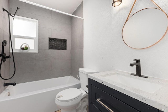 full bathroom with vanity, tiled shower / bath combo, and toilet