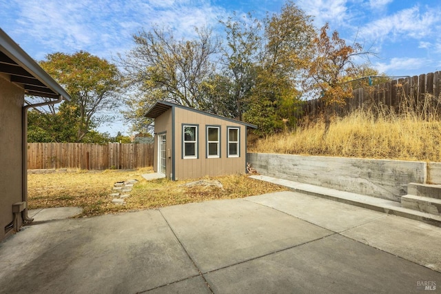 view of outbuilding featuring a fenced backyard and an outbuilding