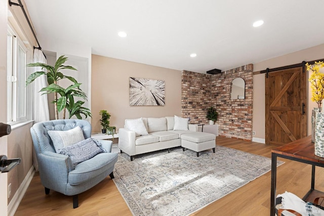 living room featuring wood-type flooring and a barn door