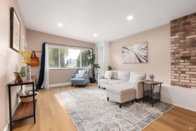 living area featuring light wood finished floors, baseboards, and recessed lighting