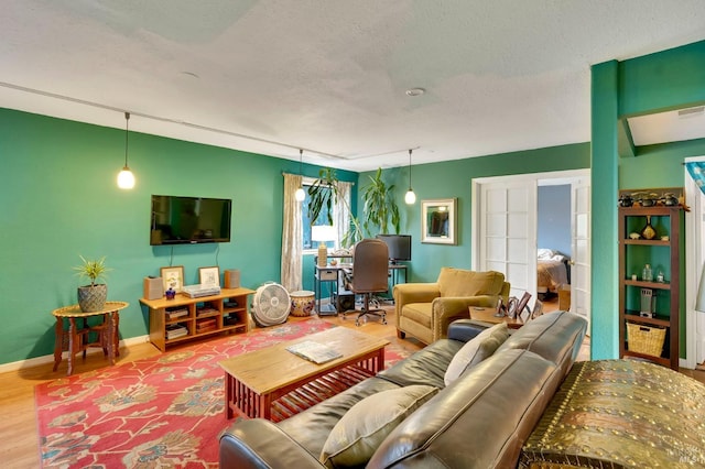 living room with french doors, wood-type flooring, and a textured ceiling