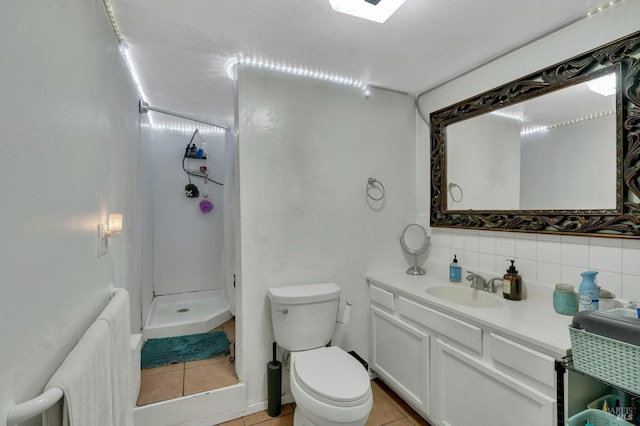 bathroom with tasteful backsplash, tile patterned floors, a textured ceiling, toilet, and vanity