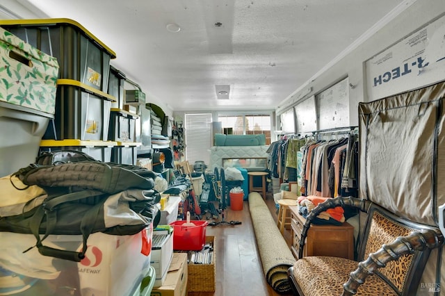 miscellaneous room with hardwood / wood-style flooring, crown molding, and a textured ceiling