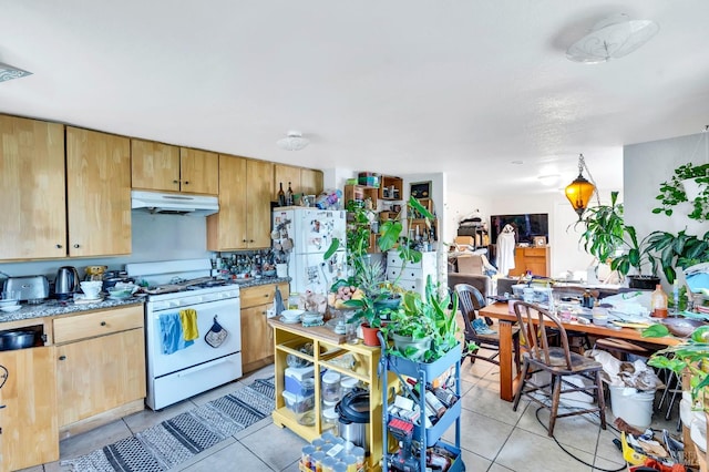 kitchen with light tile patterned floors and white appliances