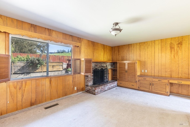 840 W Railroad Ave, Cotati, CA 94931 - unfurnished living room featuring a fireplace, wooden walls, visible vents, and carpet floors
