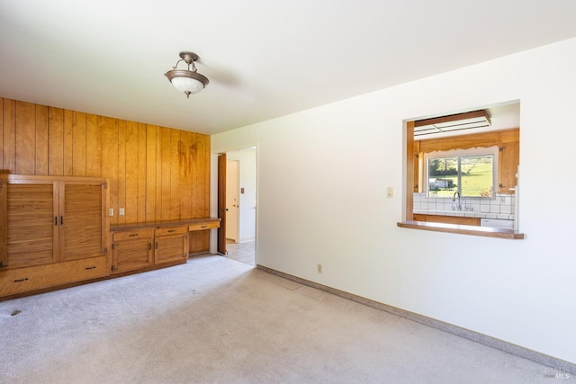 840 W Railroad Ave, Cotati, CA 94931 - unfurnished bedroom featuring baseboards, wood walls, light colored carpet, and a sink