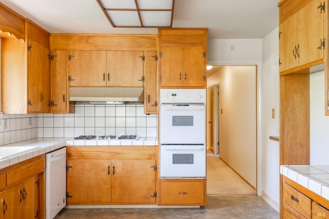 840 W Railroad Ave, Cotati, CA 94931 - kitchen with a sink, tile counters, under cabinet range hood, tasteful backsplash, and white appliances