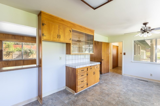 840 W Railroad Ave, Cotati, CA 94931 - kitchen featuring stone finish flooring, brown cabinetry, tile countertops, and baseboards