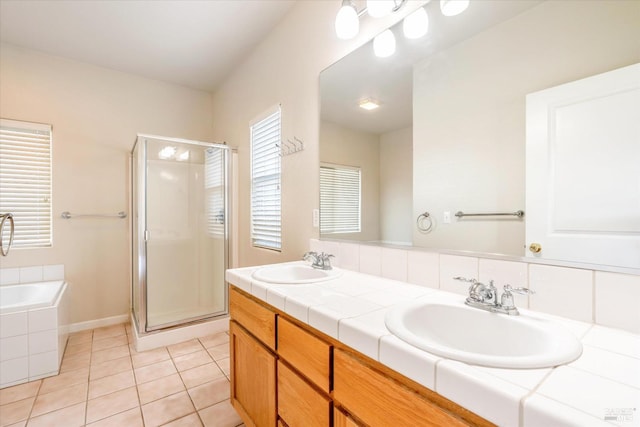 bathroom with vanity, tile patterned floors, and plus walk in shower