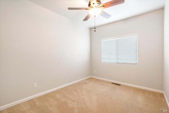 carpeted spare room featuring ceiling fan