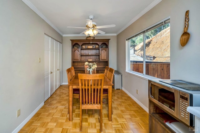 dining room with ornamental molding, ceiling fan, and light parquet floors