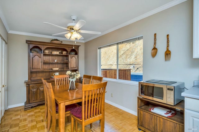 dining area with ornamental molding, light parquet floors, and ceiling fan