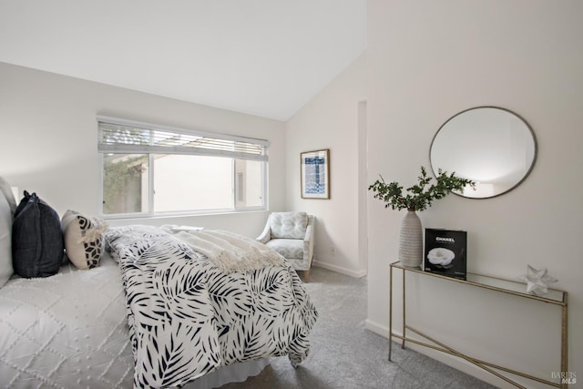 bedroom with lofted ceiling and light carpet