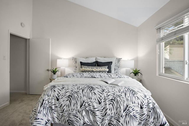 bedroom featuring lofted ceiling and carpet floors