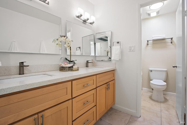 bathroom with tile patterned floors, vanity, and toilet