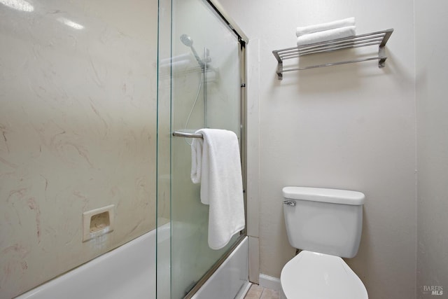 bathroom with shower / bath combination with glass door and toilet