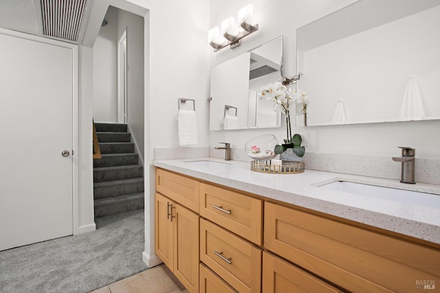 bathroom with tile patterned flooring and vanity