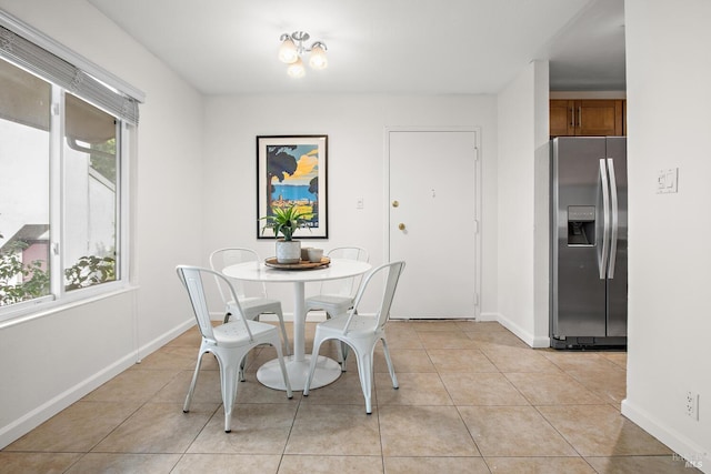 tiled dining room featuring plenty of natural light