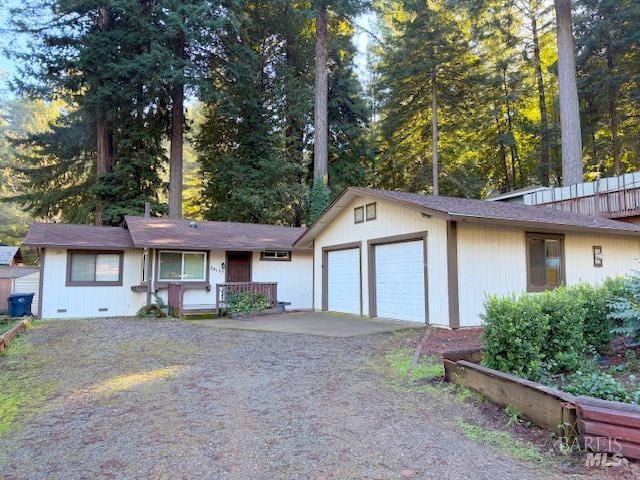 ranch-style home with central AC and a garage