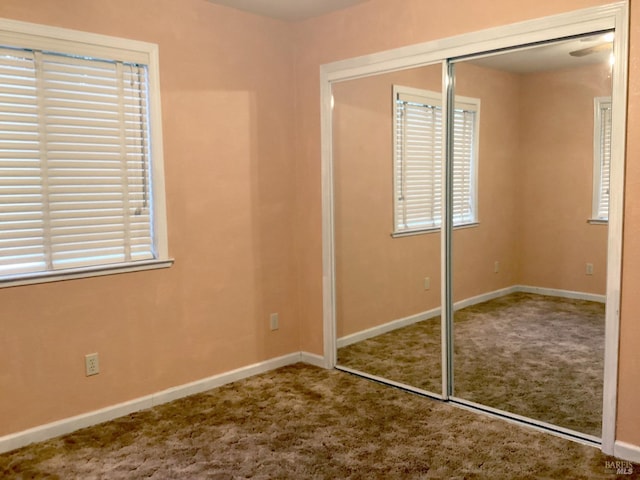 unfurnished bedroom with carpet floors and a closet