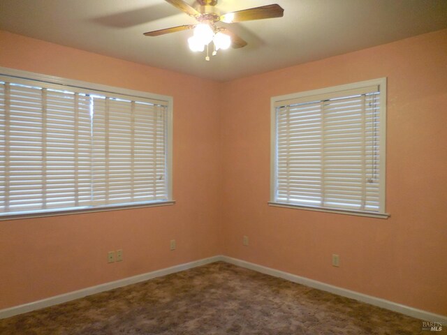 spare room featuring carpet and ceiling fan