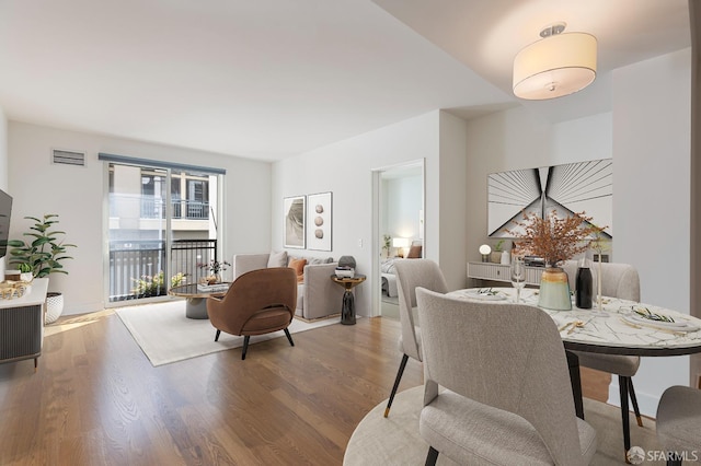 dining space with hardwood / wood-style flooring