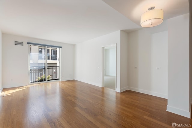 unfurnished room featuring hardwood / wood-style flooring