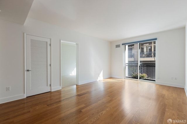 unfurnished room featuring hardwood / wood-style flooring