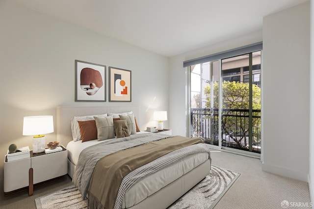 bedroom featuring light carpet and access to outside