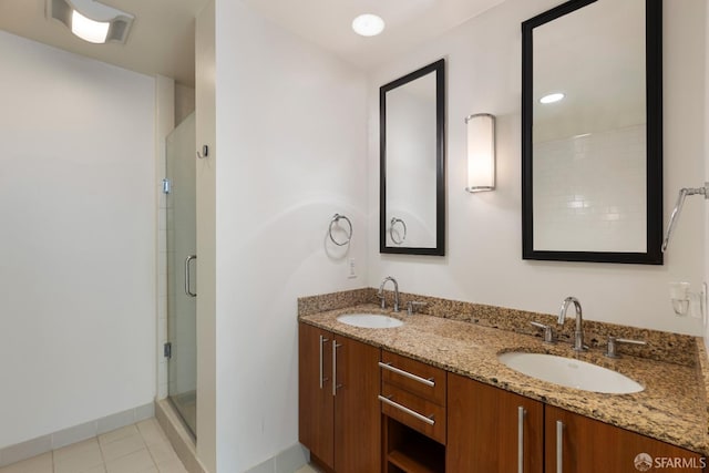 bathroom with tile patterned floors, vanity, and a shower with shower door